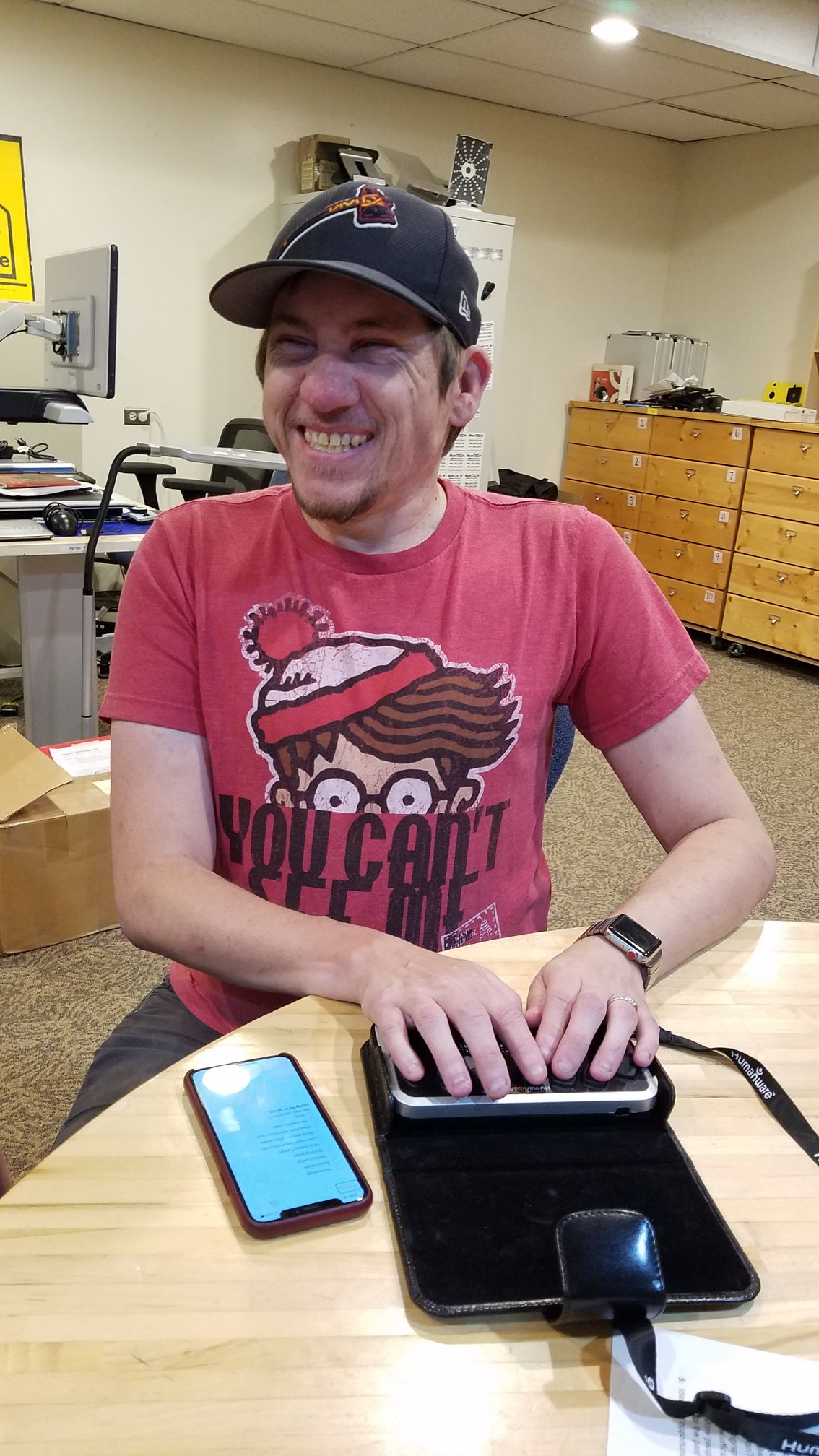 Ed using a braille display during a demonstration at the MonTech office.